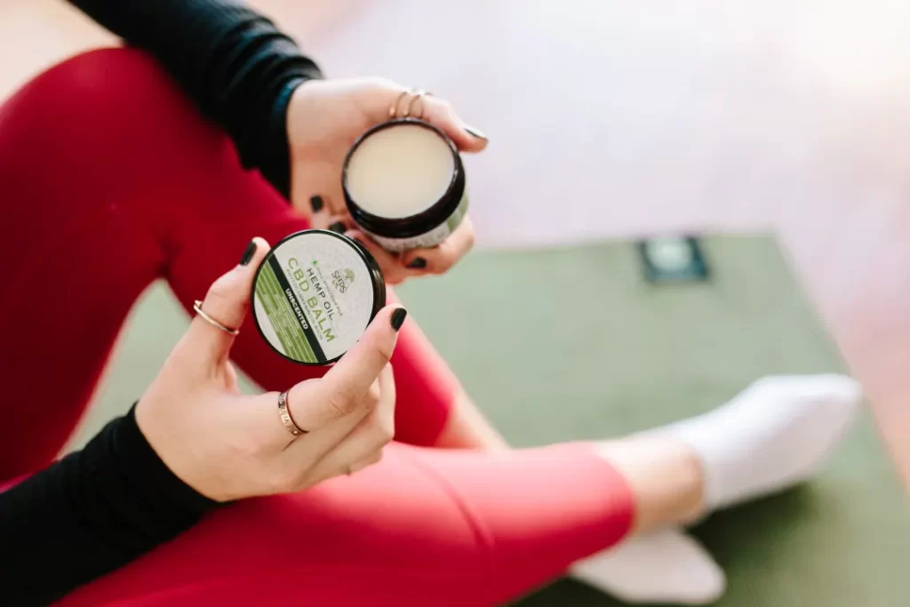 Woman using diamond CBD balm.