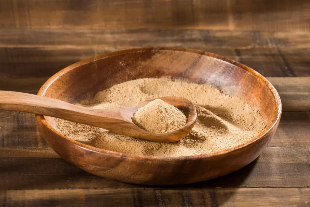 Maca powder in wooden bowl