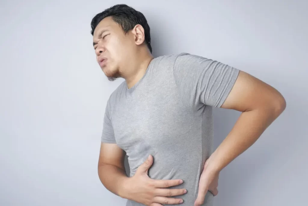man suffering from back pain inflammation