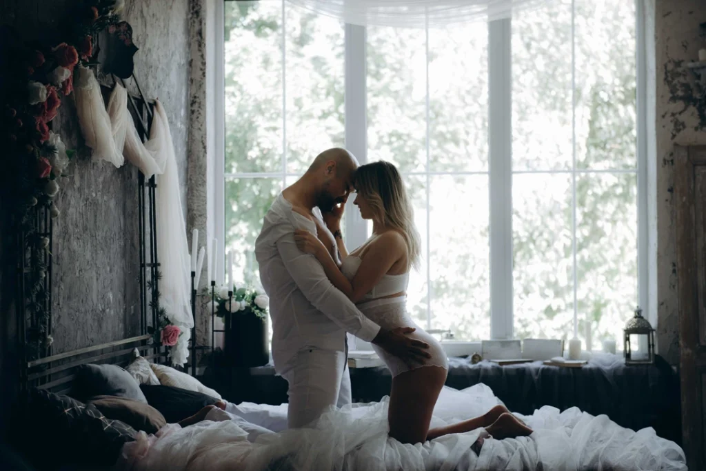 Man and woman kneeling for kissing each other.