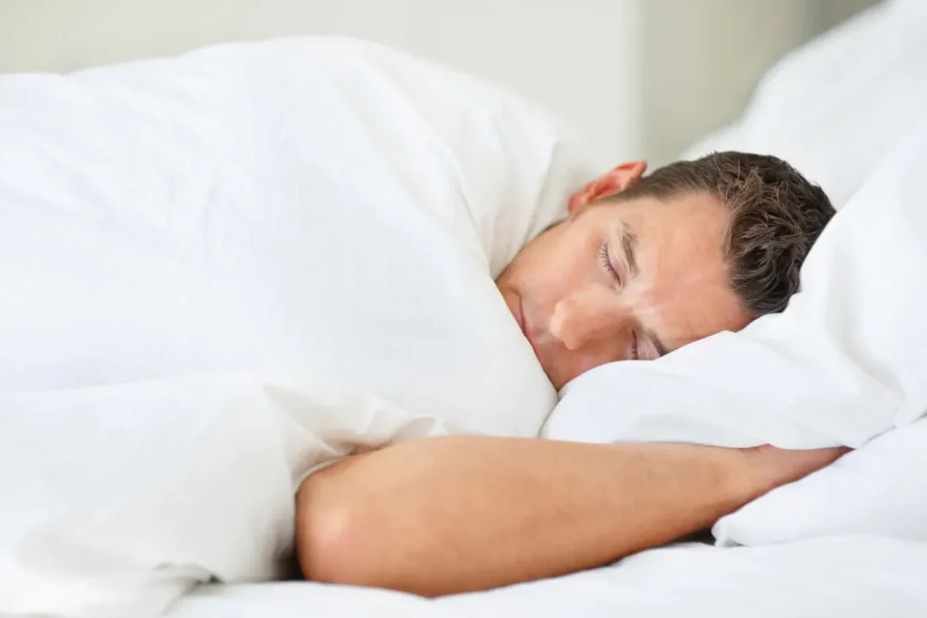 A man sleeping in the bed.
