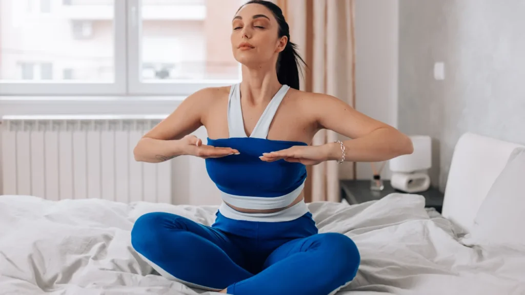 Lady is doing deep breathing exercise.