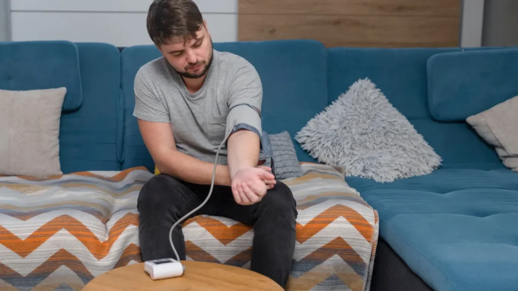 Man is measuring his blood pressure.